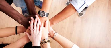 Team of people with hands on top of each other